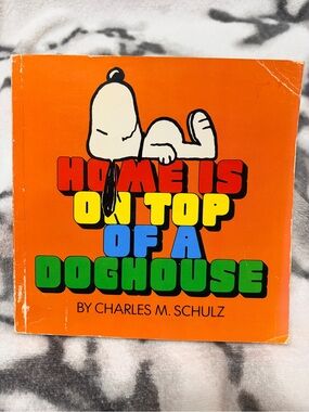 1983 Peanuts Paperback Book “Home is on Top of a Dog House” by Charles M. Schulz